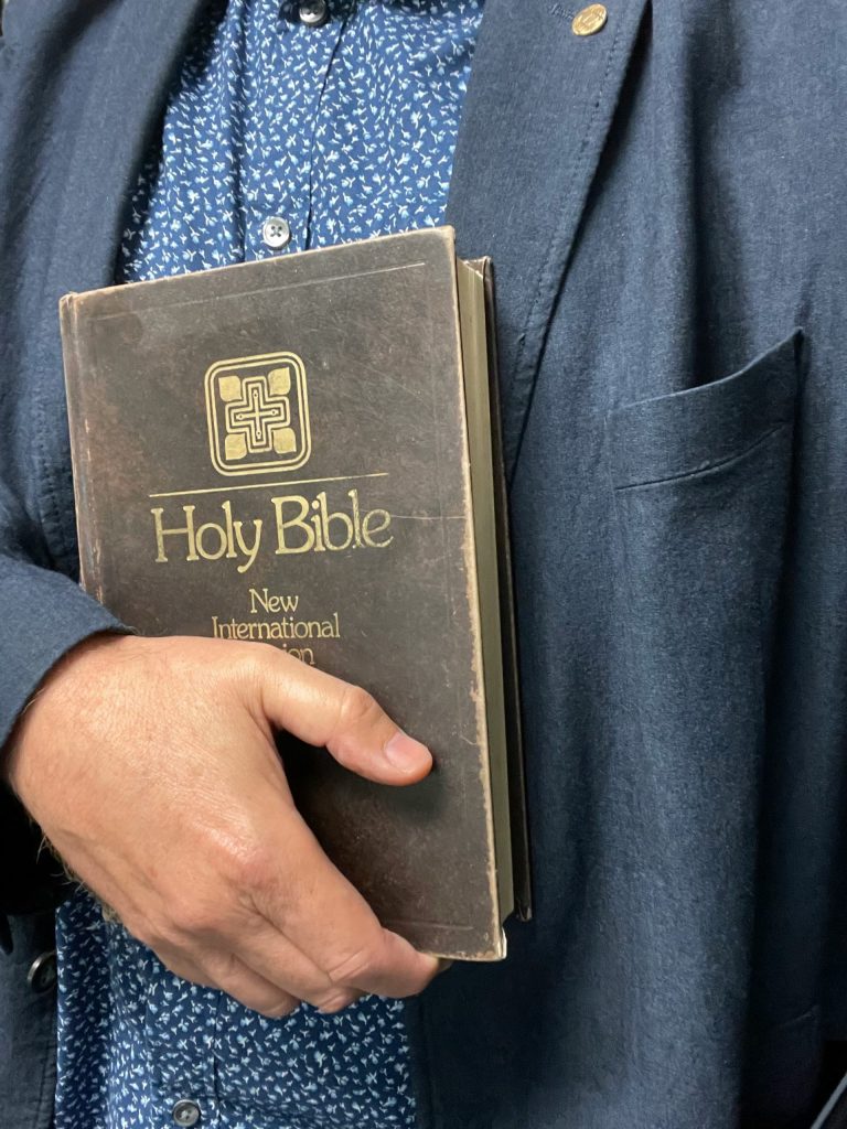 a man holding a bible in his hands